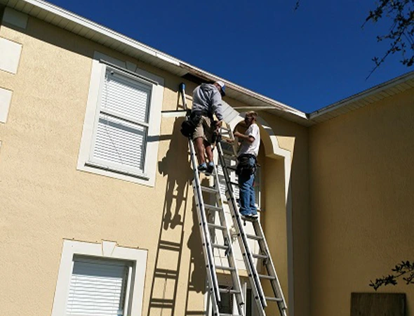 Beautifully repainted two-story home exterior in Palm Bay, FL showing high-quality professional painting results.