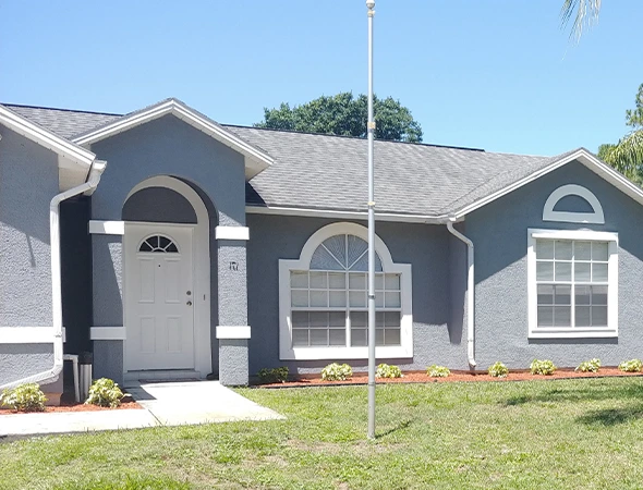 professional exterior painting on a beautiful home in Melbourne, FL showing clean finish and curb appeal.